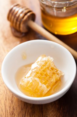 Petek ve bal kavanozuna ahşap zemin üzerinde