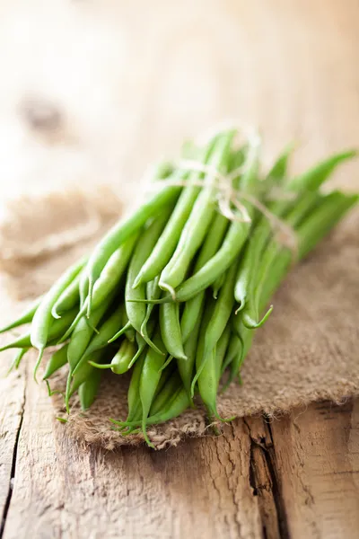 Färska gröna bönor över trä bakgrund — Stockfoto