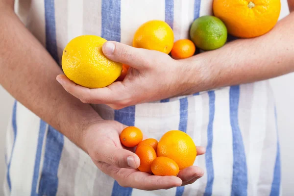 Man hands holding various citrus fruits — Stock Photo, Image