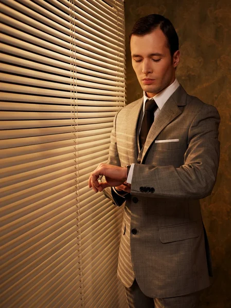 Retro businessman looking at his watch — Stock Photo, Image