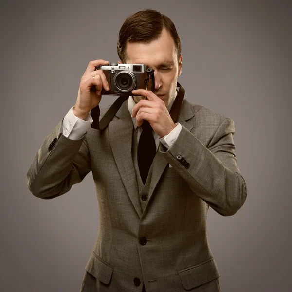 Businessman with a retro camera — Stock Photo, Image