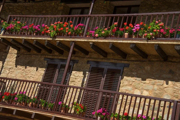 Building facade with lot of flower pots — Stock Photo, Image