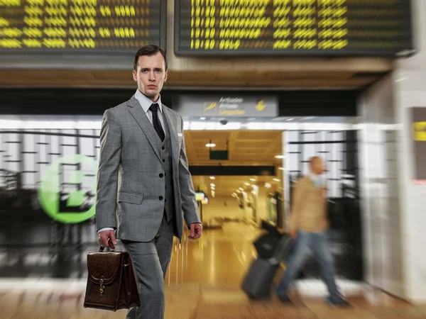 Man in classic grey suit with briefcase in airport — Stock Photo, Image