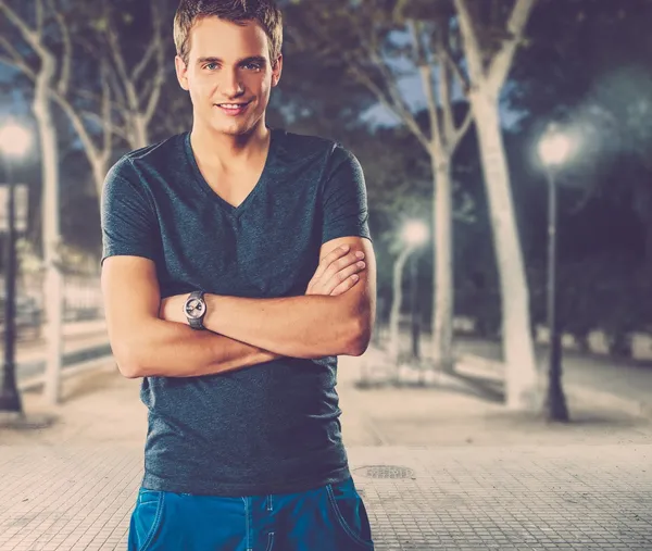 Young man in shirt outdoors at night — Stock Photo, Image