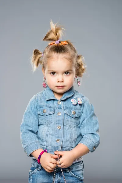 Funny little girl isolated on grey — Stock Photo, Image