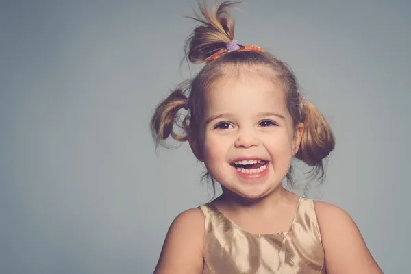 Sorrindo menina pequena isolado em cinza — Fotografia de Stock