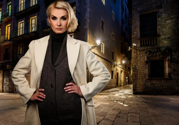 Blond woman in white coat — Stock Photo, Image