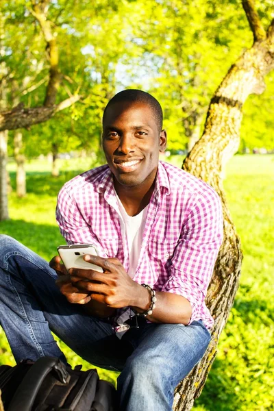 Young black guy in park — Stock Photo, Image