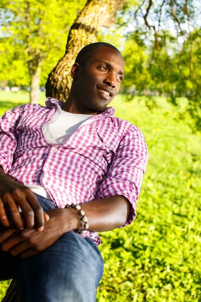 Young black guy in park — Stock Photo, Image