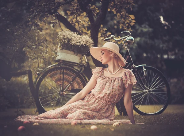 Retro woman with bicycle — Stock Photo, Image