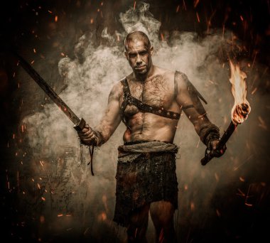 Gladiator standing in a smoke with torch and sword clipart
