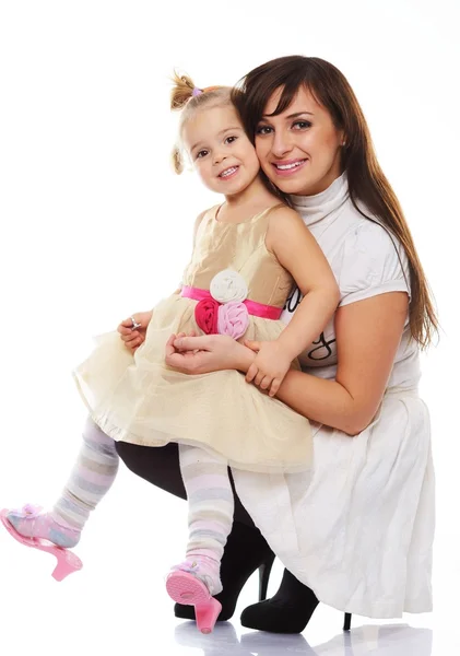 Happy smiling young mother holding her little daughter — Stock Photo, Image