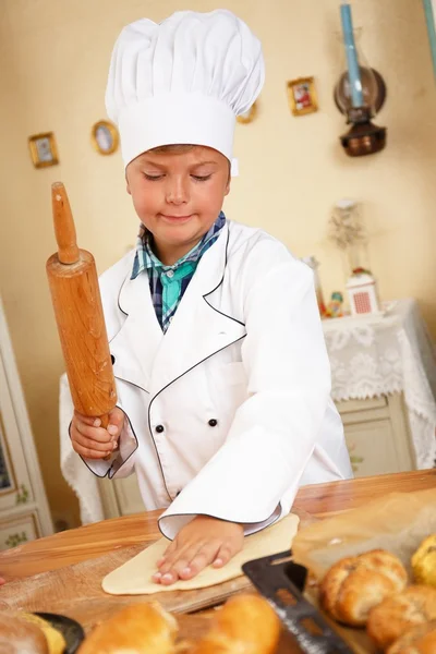 Young cook boy making homemade pastry — Stock Photo, Image
