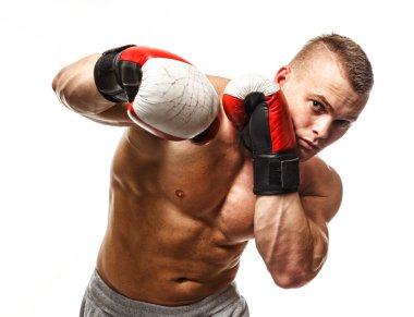 Handsome muscular young man wearing boxing gloves clipart