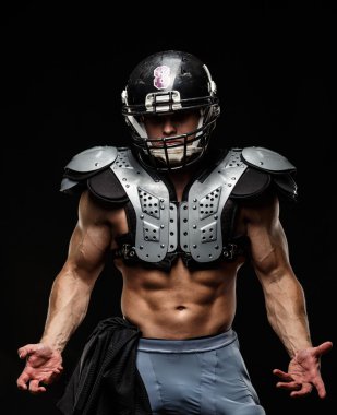 American football player wearing helmet and protective armour clipart