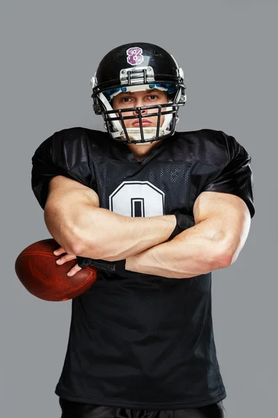 Amerykański piłkarz z piłką na sobie kask i jersey — Zdjęcie stockowe