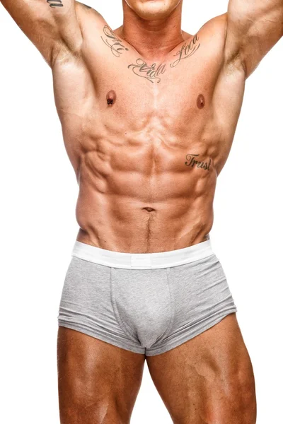 Человек с красивым мышечным татуированным туловищем в нижнем белье — стоковое фото