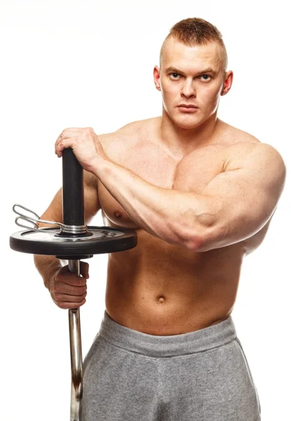 Handsome man with muscular torso lifting weights — Stock Photo, Image