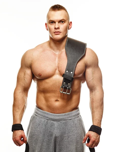 Muscular young sportsman with weight lifting belt — Stock Photo, Image