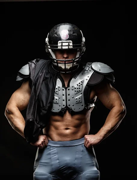 American football player wearing helmet and protective armour — Stock Photo, Image