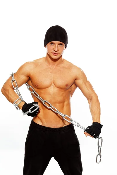 Handsome muscular man in beanie hat with chain — Stock Photo, Image