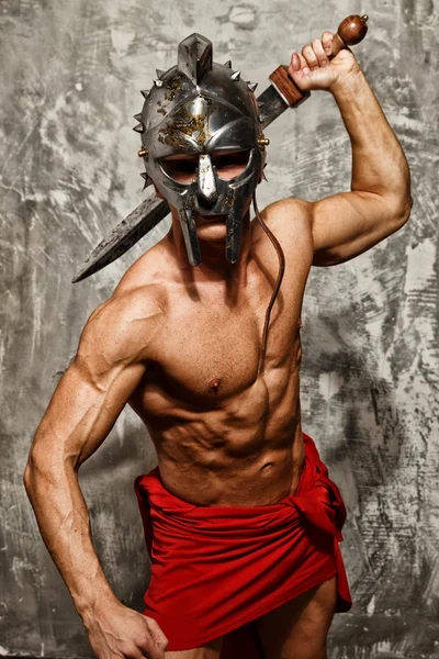 Gladiator with muscular body with sword and helmet — Stock Photo, Image