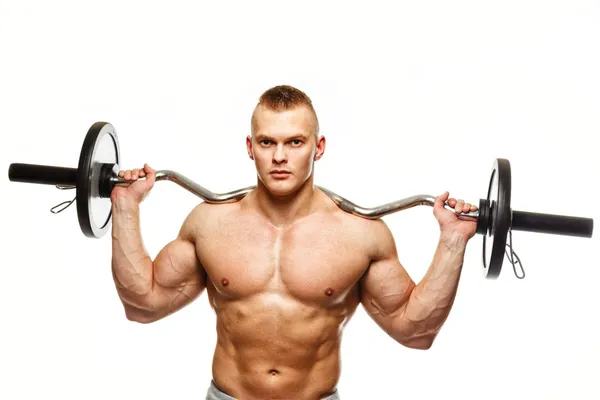 Handsome man with muscular torso lifting weights — Stock Photo, Image