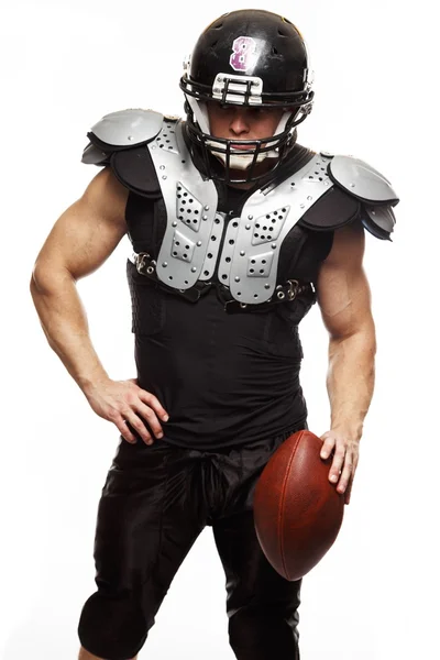 American football player with ball wearing helmet and protective shields — Stock Photo, Image