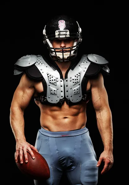 American football player with ball wearing helmet and protective shields — Stock Photo, Image