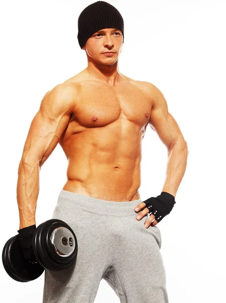 Handsome young muscular man exercising with dumbbells — Stock Photo, Image