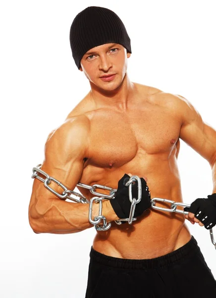 Handsome muscular man in beanie hat with chain — Stock Photo, Image