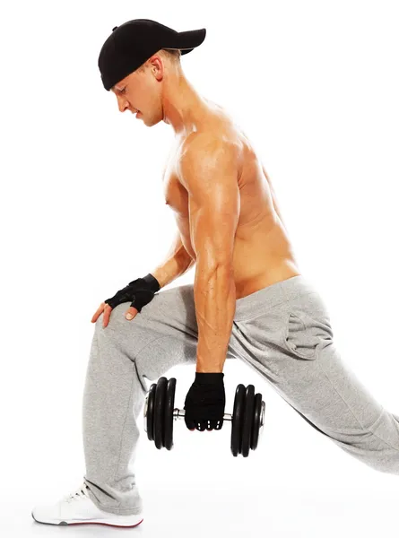 Handsome young muscular man exercising with dumbbells — Stock Photo, Image