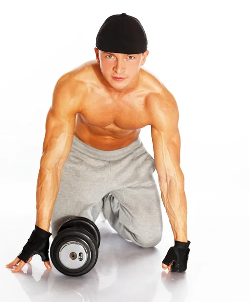 Handsome young muscular man exercising with dumbbells — Stock Photo, Image