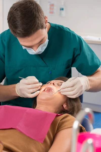 Young woman and man doctor at dentist's surgery — Stock Photo, Image