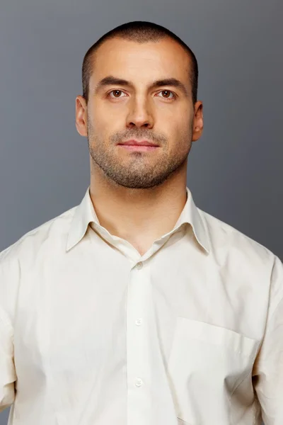 Handsome man in white shirt isolated on grey background — Stock Photo, Image