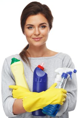 Beautiful cheerful brunette woman in gloves holding different cleaning stuff clipart