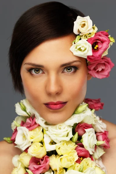 花の首輪と若い美しいブルネットの女性 — ストック写真