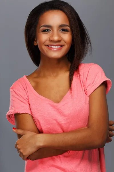 Cheerful young black woman isolated on grey background — Stock Photo, Image