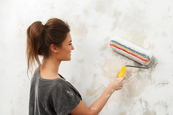 Happy beautiful young woman doing wall painting — Stock Photo, Image