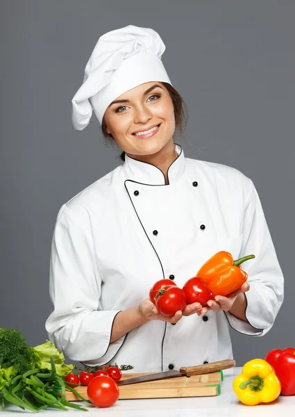 Beautiful young woman holding fresh paprika — Stock Photo, Image