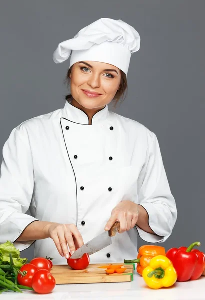 Beautiful young woman cook cutting vegetables — Stock Photo, Image