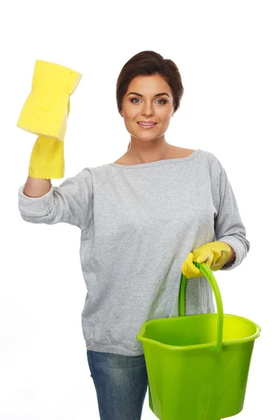 Beautiful cheerful brunette woman in gloves with sponge and bucket — Stock Photo, Image