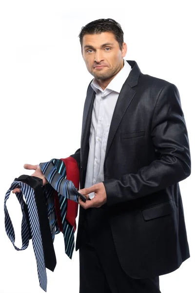 Bewildered handsome man in black suit and choice of ties — Stock Photo, Image