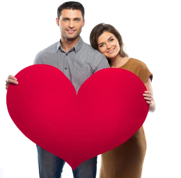 Happy couple in shirt and dress holding handmade paper heart — Stock Photo, Image