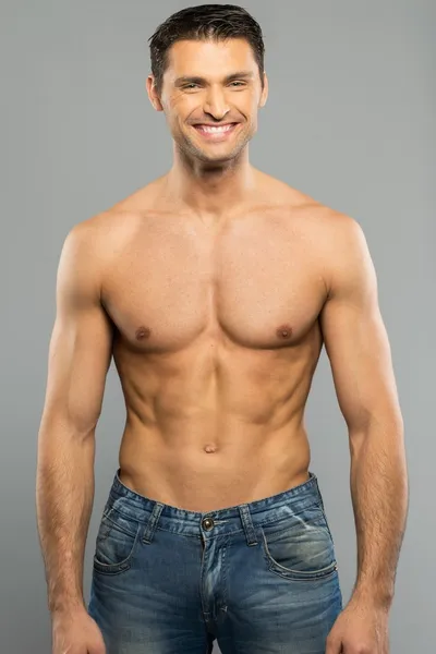 Handsome young man in blue jeans with naked torso — Stock Photo, Image