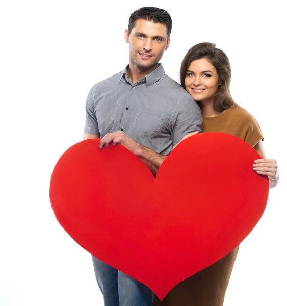 Happy couple in shirt and dress holding handmade paper heart — Stock Photo, Image