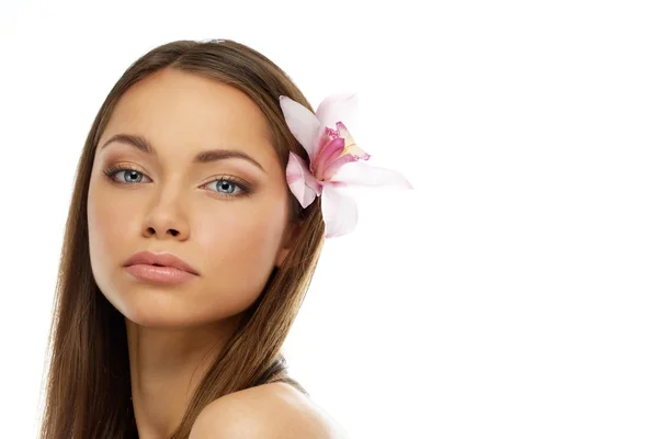 Young beautiful brunette woman with orchid flower — Stock Photo, Image