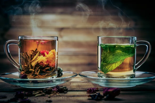 Glass cups with tea against wooden background — Stock Photo, Image