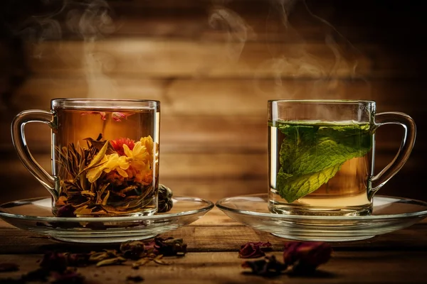 Glass cups with tea against wooden background — Stock Photo, Image