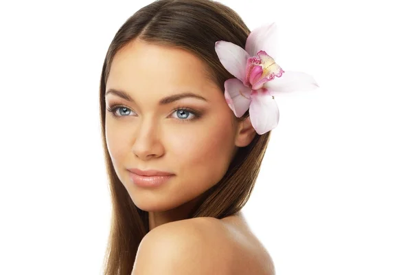 Young beautiful brunette woman with orchid flower Stock Image